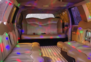 Detailed view of passenger seating at rear of vehicle with tinted windows and doors