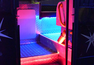 View of door, TV screen and bar area