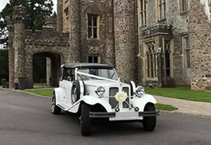 Beauford Tourer outside a castle